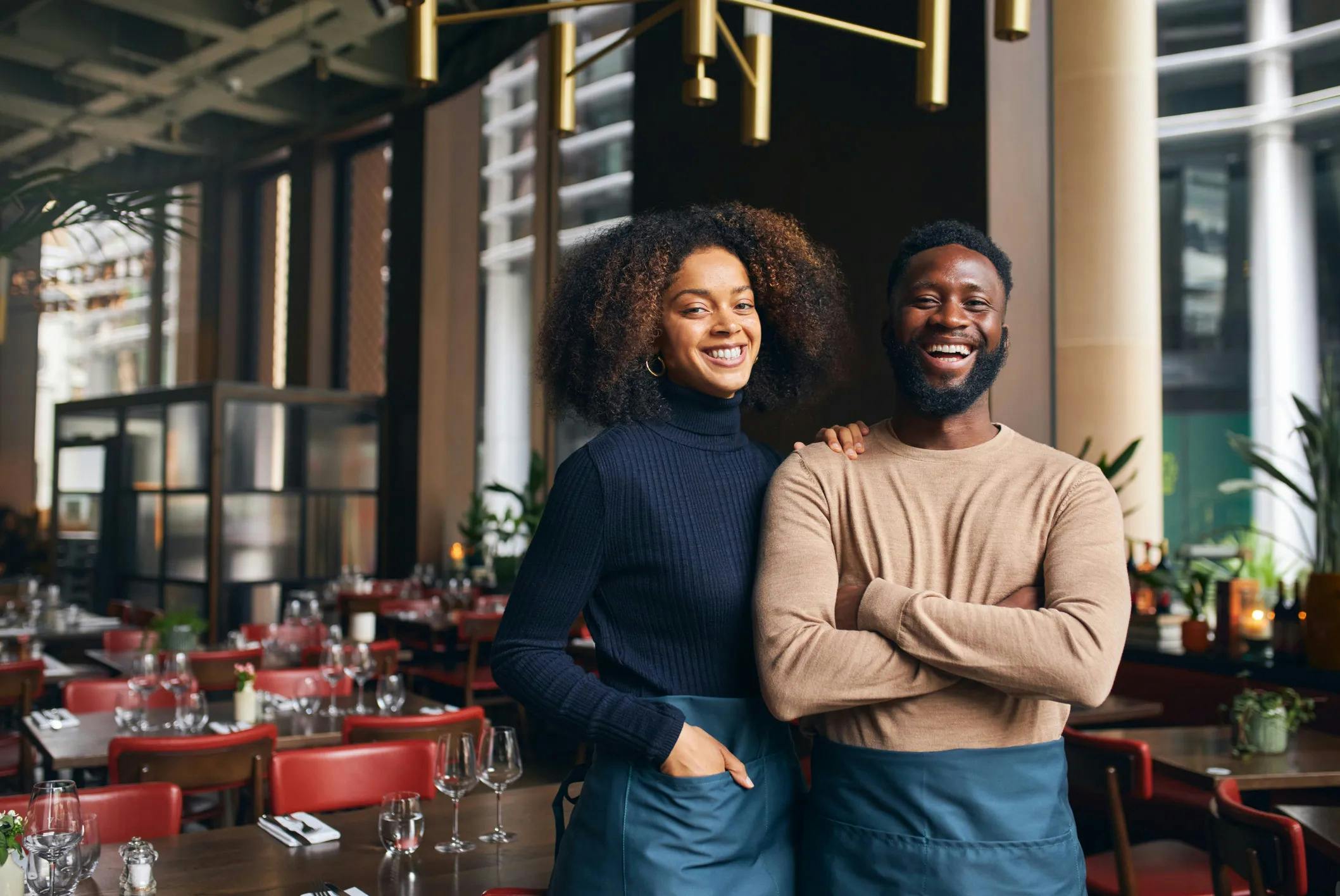Picture of a woman and man business owner standing in a restaurant