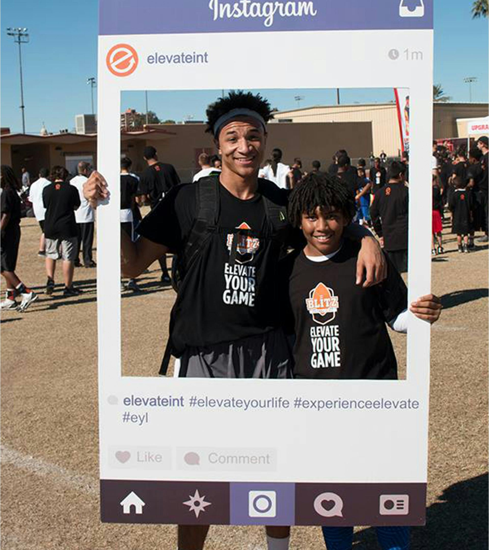 2 brother holding a life size Instagram interface with a cut out showing their faces