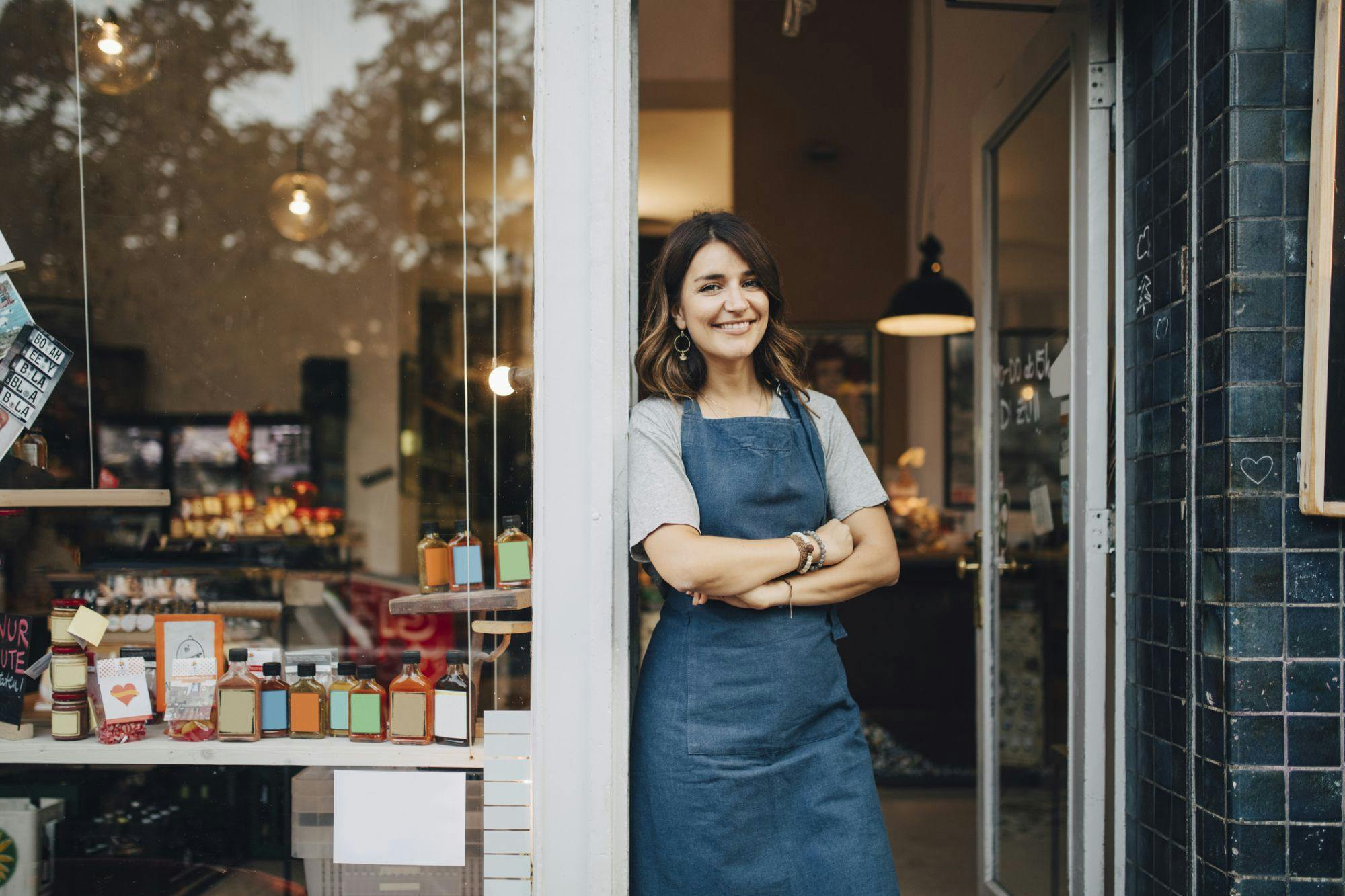 Business woman leaning on the side of her business door