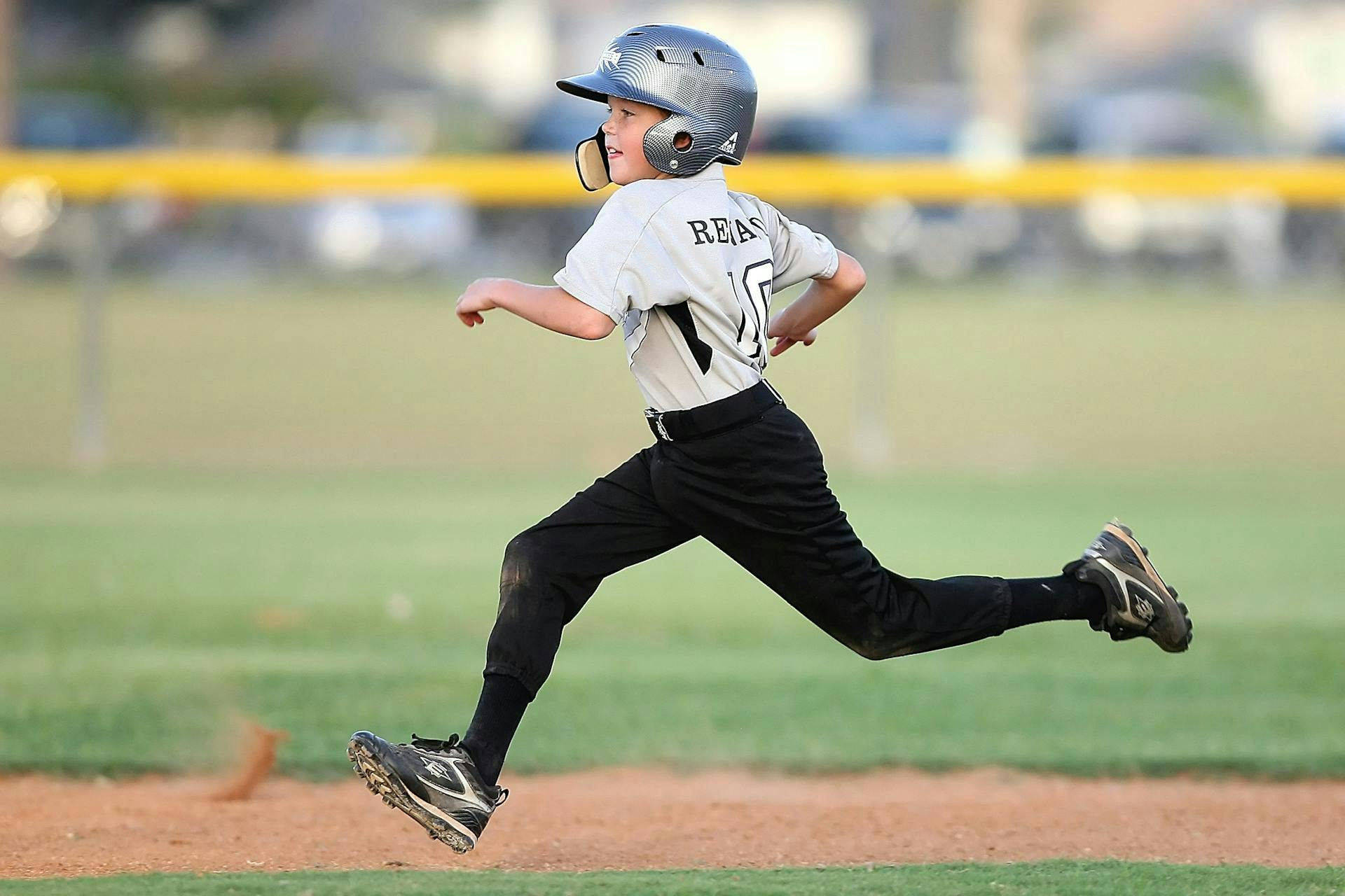 Little boy running between bases